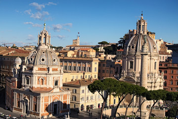 View to rooftops of Rome skyline with domes church Santa Maria di Loreto and dome church Nome di...