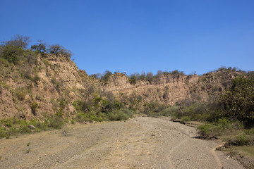 dry river bed with sandy cliffs