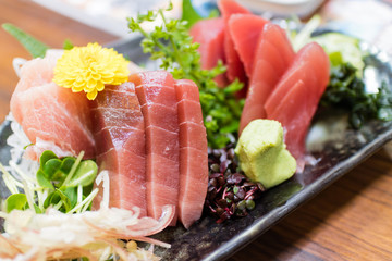Fresh foods, sashimi salmon, tuna with  aromatic herbs, spices and vegetables