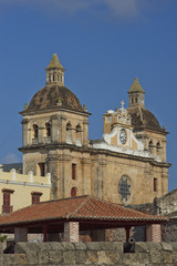 Fototapeta na wymiar Towers and dome of the historic Iglesia de San Pedro Claver in the Spanish colonial city of Cartagena in Colombia.