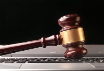 Judge gavel on laptop.
