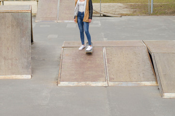 Cool skater girl riding a long board at the city.