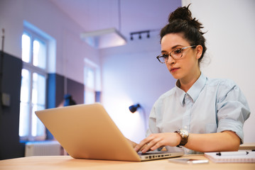 Female student study in library using laptop and searching internet