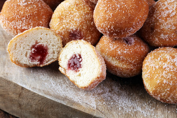 Bomboloni - traditional Italian doughnuts stuffed with strawberry jam