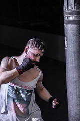 sports man Boxing bag in the gym