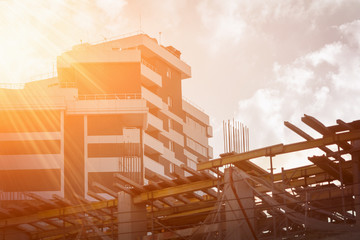 Construction crane and a building house. Sky,clouds,sunlight