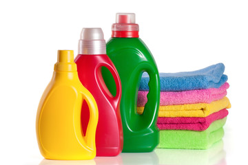 bottle laundry detergent and conditioner with towels isolated on white background