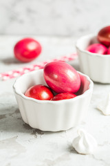 .Colored eggs in a white bowl on the Easter holiday