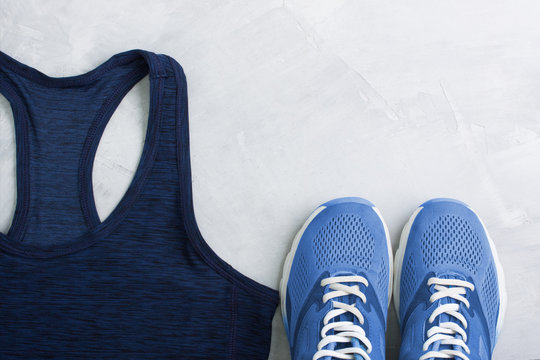 Flatlay sport composition with outfit blue sneakers and t-shirt