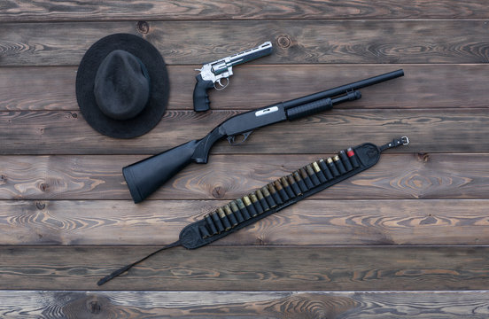 Hat, a rifle and a revolver, a vintage, a gangster, a cowboy, a mafia
