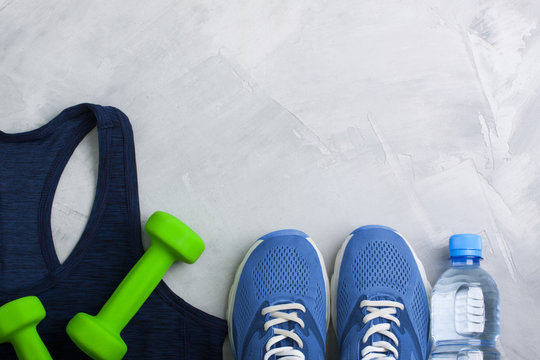 Flatlay sport composition with equipment outfit blue sneakers and t-shirt