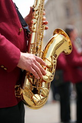 hand of player and the saxophone in the main square