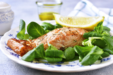 Grilled organic salmon with salad leaves.