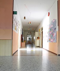 inside of a long corridor of the kindergarten with drawings on t