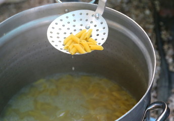 pasta cooked in boiling water in large pot of Italian restaurant