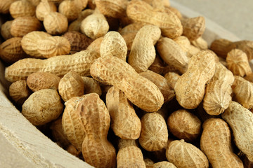 Peanuts in a wooden bowl - closeup.
