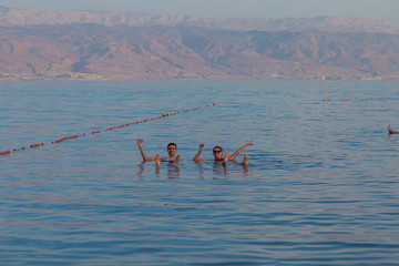 People floating at the Dead sea, Israel