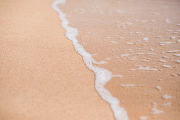 Soft wave Of Blue Ocean On Sandy Beach. Background.