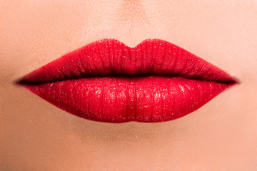 Beautiful female lips of red color close-up. Closed mouth.