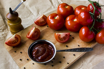 Tomato sauce with pepper. To meat and other main courses. Fresh tomatoes on a wooden board