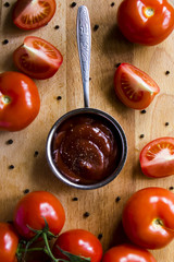 Tomato sauce with pepper. To meat and other main courses. Fresh tomatoes on a wooden board