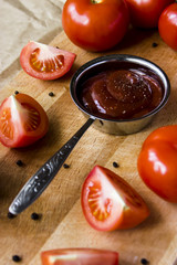 Tomato sauce with pepper. To meat and other main courses. Fresh tomatoes on a wooden board
