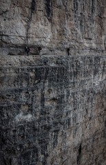 Three climbers in the wall of Via Ferrata, Dolomites, Italy