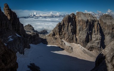Glacier in the mountains above the clouds on a perfect day, Dolomites, Italy