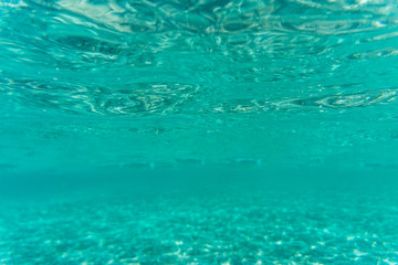 Fototapeta na wymiar Underwater blue background with sunbeams