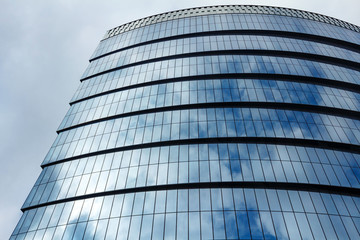 Fototapeta na wymiar Fragment of a glass skyscraper in business district