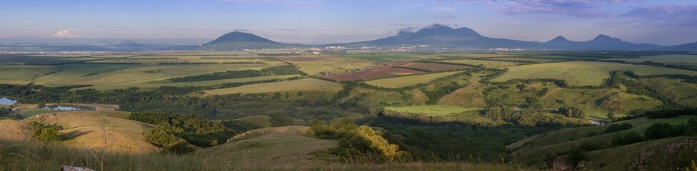  Stavropol Territory. panorama. The city of Pyatigorsk is surrounded by mountains and fields in the summer morning.