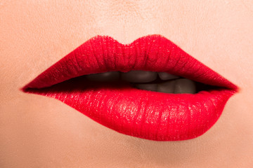 Obraz premium Beautiful female lips close-up. She Bites her lower lip.
