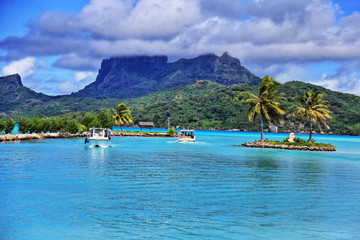 View from Bora Bora airport. Beautiful palms, mountains and blue sea. French Polynesia, South Pacific Ocean. HDR (High dynamic range) picture.