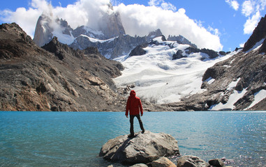 Man, blue lake, glacier and mountains. El Chalten (Argentina's Trekking Capital) - Patagonia - obrazy, fototapety, plakaty