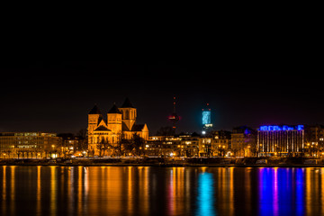 Fototapeta na wymiar Skyline of Cologne at night with the Basilica of St. Cunibert, the Cologne Tower, the Colonius and the river Rhine