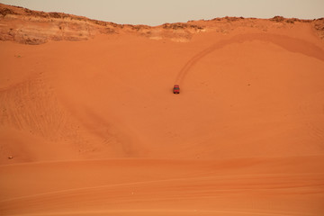 Fototapeta na wymiar Car in arabian desert . This safari experience you can't miss when in Dubai.