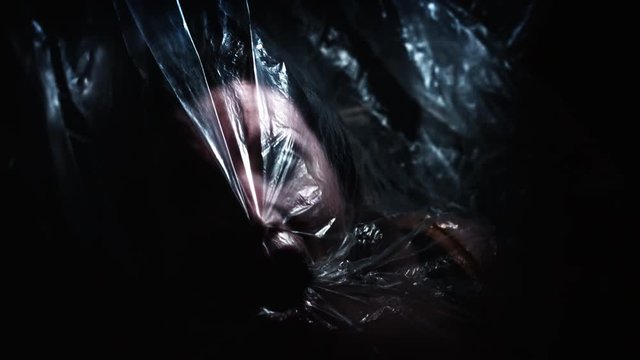 4K Horror Shot Of Dead Woman Waking up in Plastic Bag