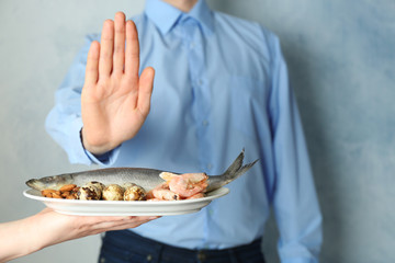 Allergy concept. Young man refusing to eat food