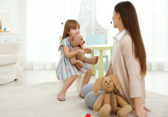 Young child psychologist working with little girl