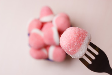 Pink gummy sweets with sugar, top view