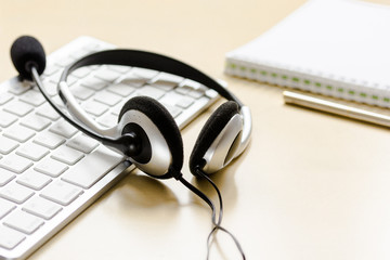 Call center support table with headset and keyboard
