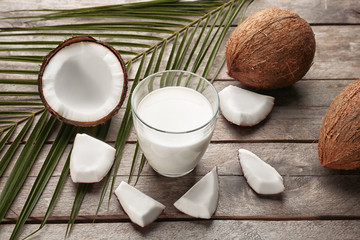 Composition with tasty coconut milk on wooden background