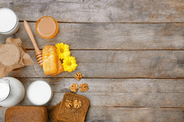 Beautiful composition of honey and milk on wooden table