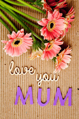 Mother's Day message with flowers on corrugated cardboard background - Mum
