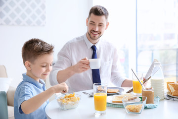 Dad and son having lunch at home