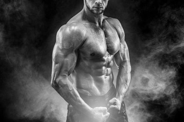 Strong bodybuilder with six pack. Man with perfect abs, shoulders,biceps, triceps and chest,...