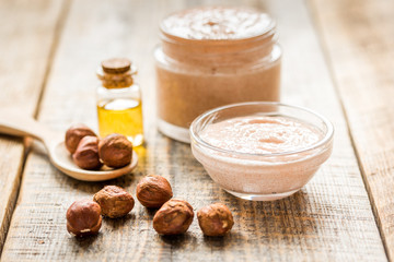 natural scrub with hazelnut on wooden table background