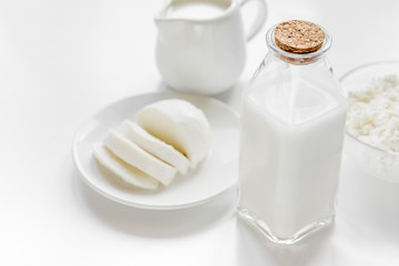Healthy food concept with milk and cottage cheese on white table