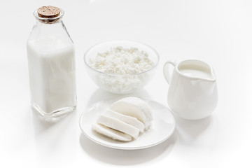 Healthy food concept with milk and cottage cheese on white table