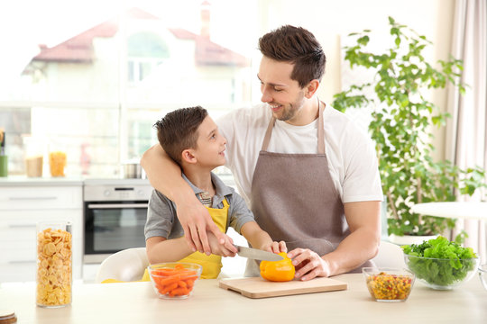 Dad and son cooking at home